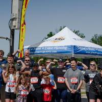 A group photo of participants flexing.